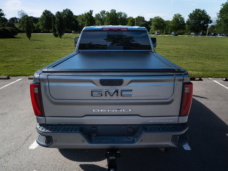 Rear view of the closed SILVEX aluminum retractable tonneau cover on a GMC Sierra Denali