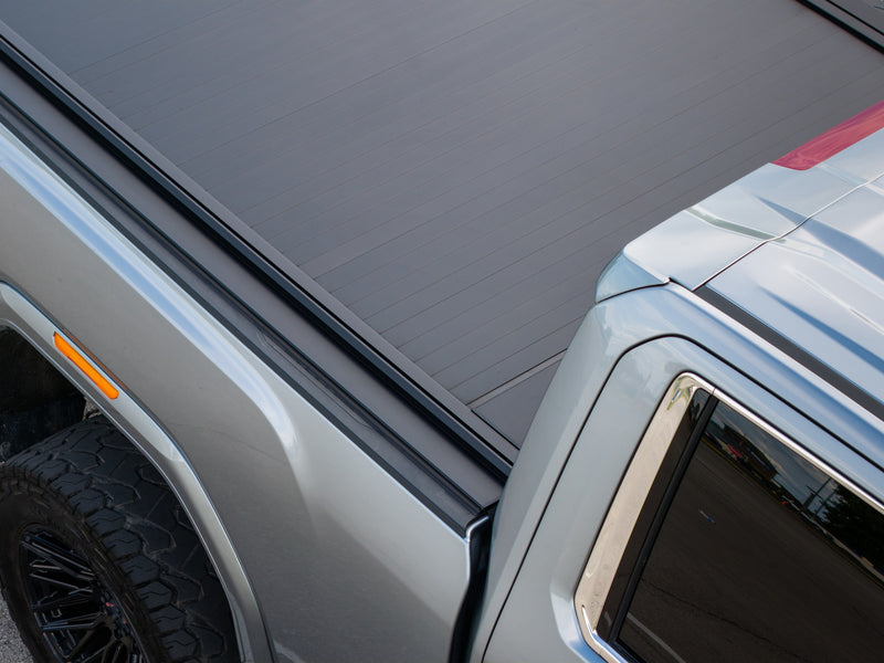 Low-angle view along the bed of the closed SILVEX electric retractable tonneau cover