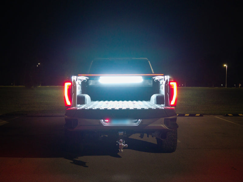Full-width red LED light bar of the SILVEX tonneau cover lit at night