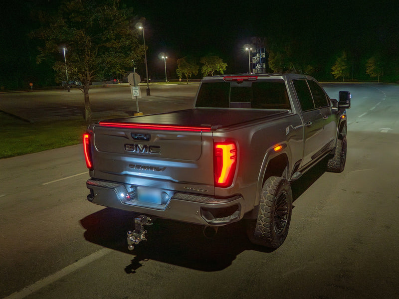 Night rear quarter view of a truck with the SILVEX tonneau cover red LED perimeter lighting on